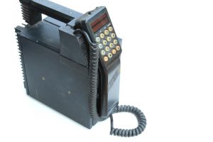 comparison of old mobile phone and freedom fence from 30 years ago